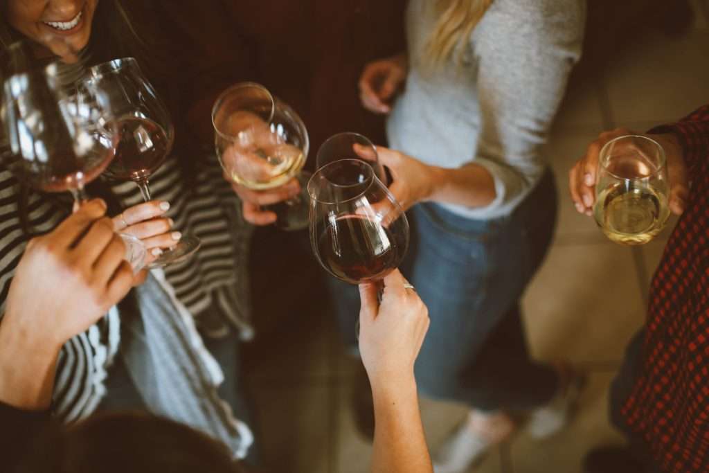 People holding up glasses of wine in one of our spaces, which are available for hire