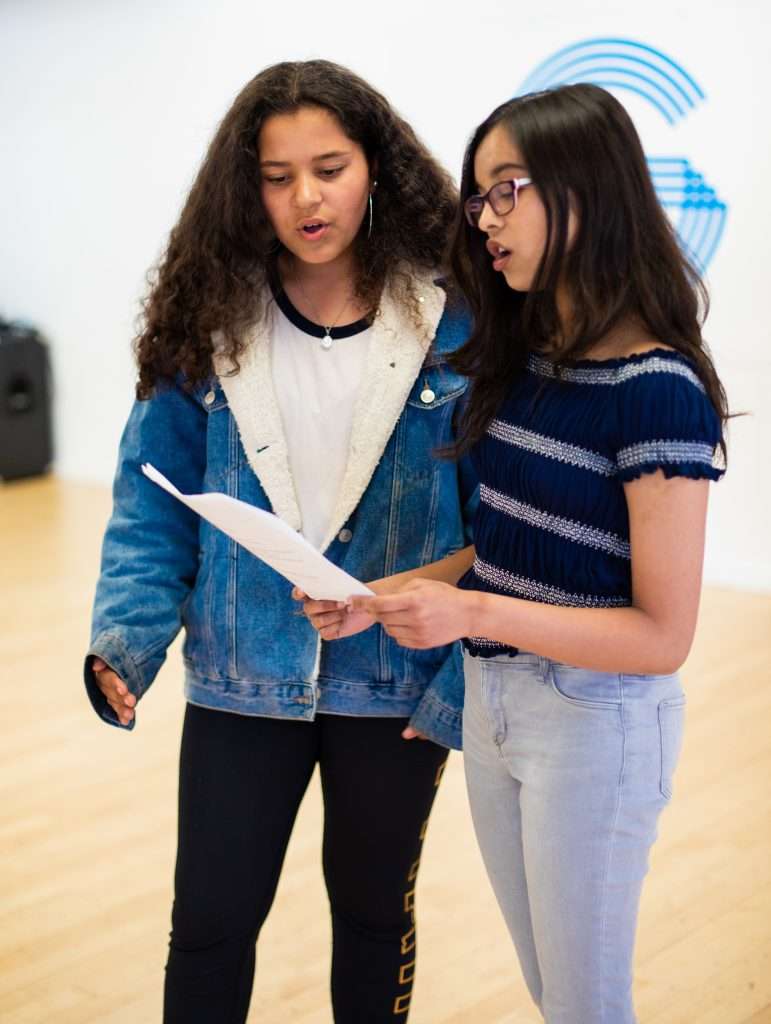 Two students looking at a script in our studio